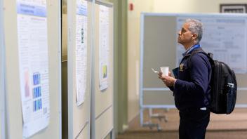 man looking at posters
