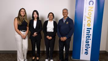 research group stands near UC Noyce Initative banner