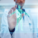 stock image of a doctor reaching toward a futuristic hologram of a human body